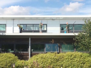 Commercial exterior cleaning team working on roof gutters, windows and façade at Hethel Engineering site in Norfolk 2016